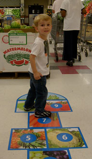 Child on hopscotch at the grocery store