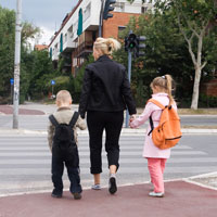 Mother with kids crossing street