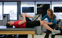 Woman exercising with a physical therapist