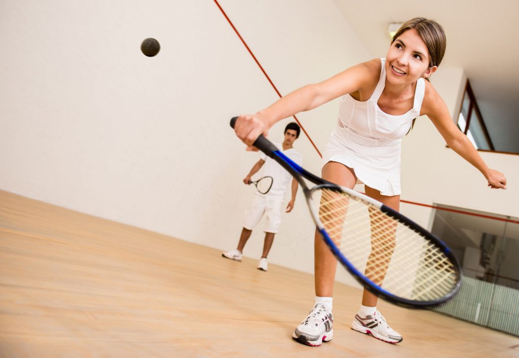 Beautiful woman playing a match of squash