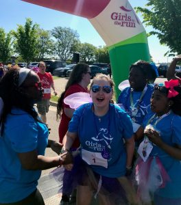 Girls cheering at the end of a Girls on the Run 5K race. 