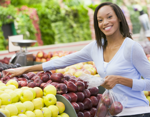 Smiling woman shopping for fruits and vegetables