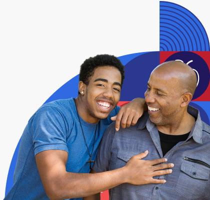 Father and teen son laughing together.