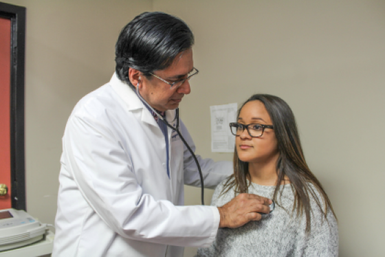 Doctor examining Patient with stethoscope 
