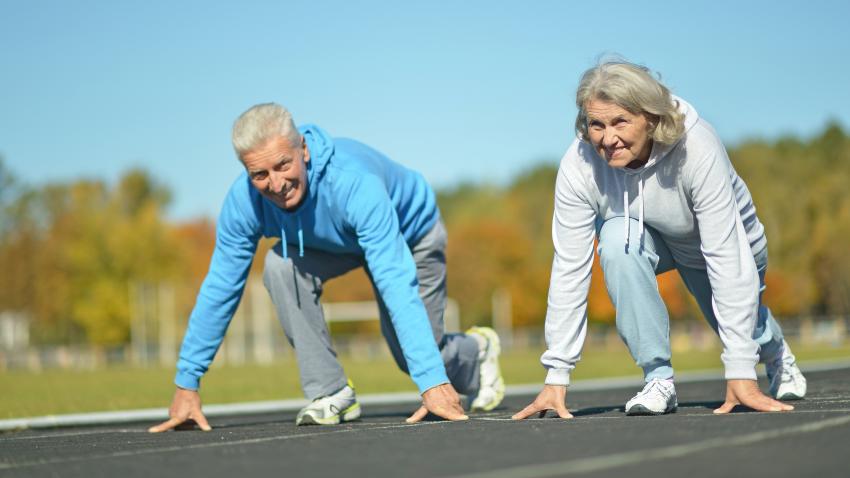 Older man and woman stretching