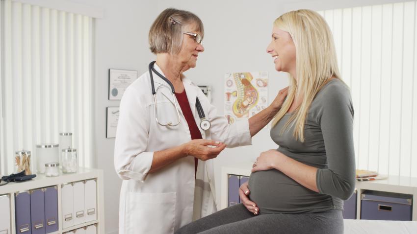 Pregnant woman talking with health care provider
