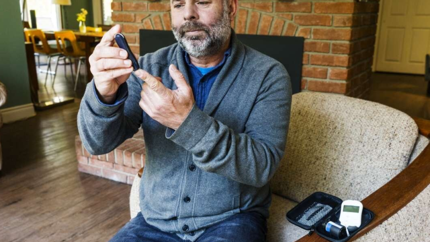 Man testing his blood sugar.