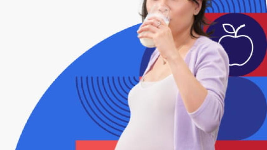 A pregnant woman drinks a glass of milk.
