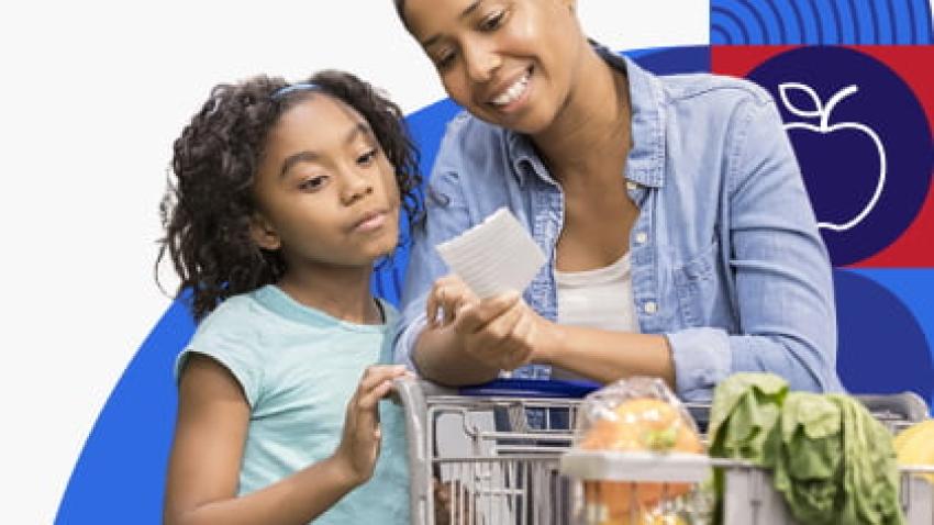 A woman and child look at a shopping list while buying produce.