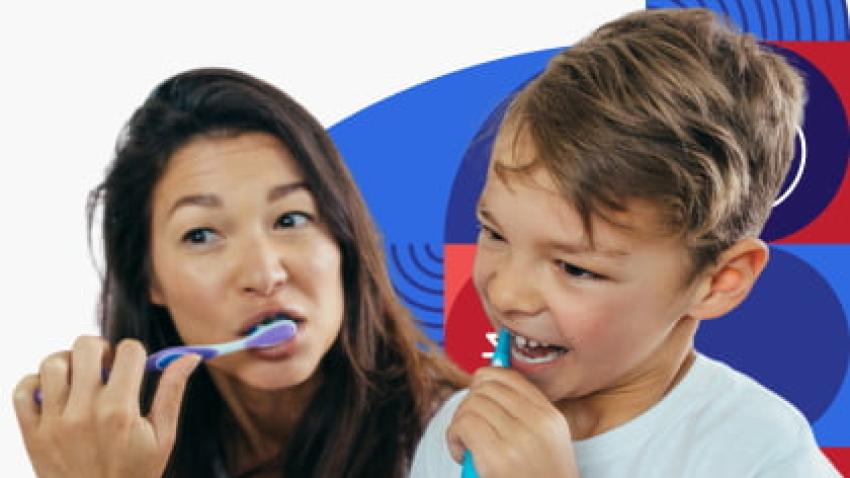 A woman and child brushing their teeth.